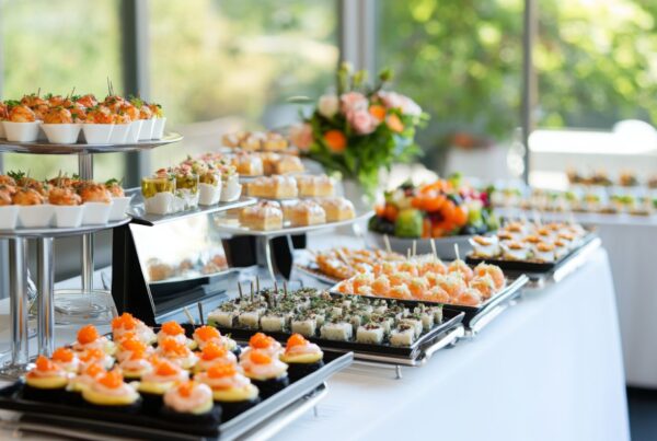 Catering buffet table with tiered stands and trays of appetizers arranged at an event